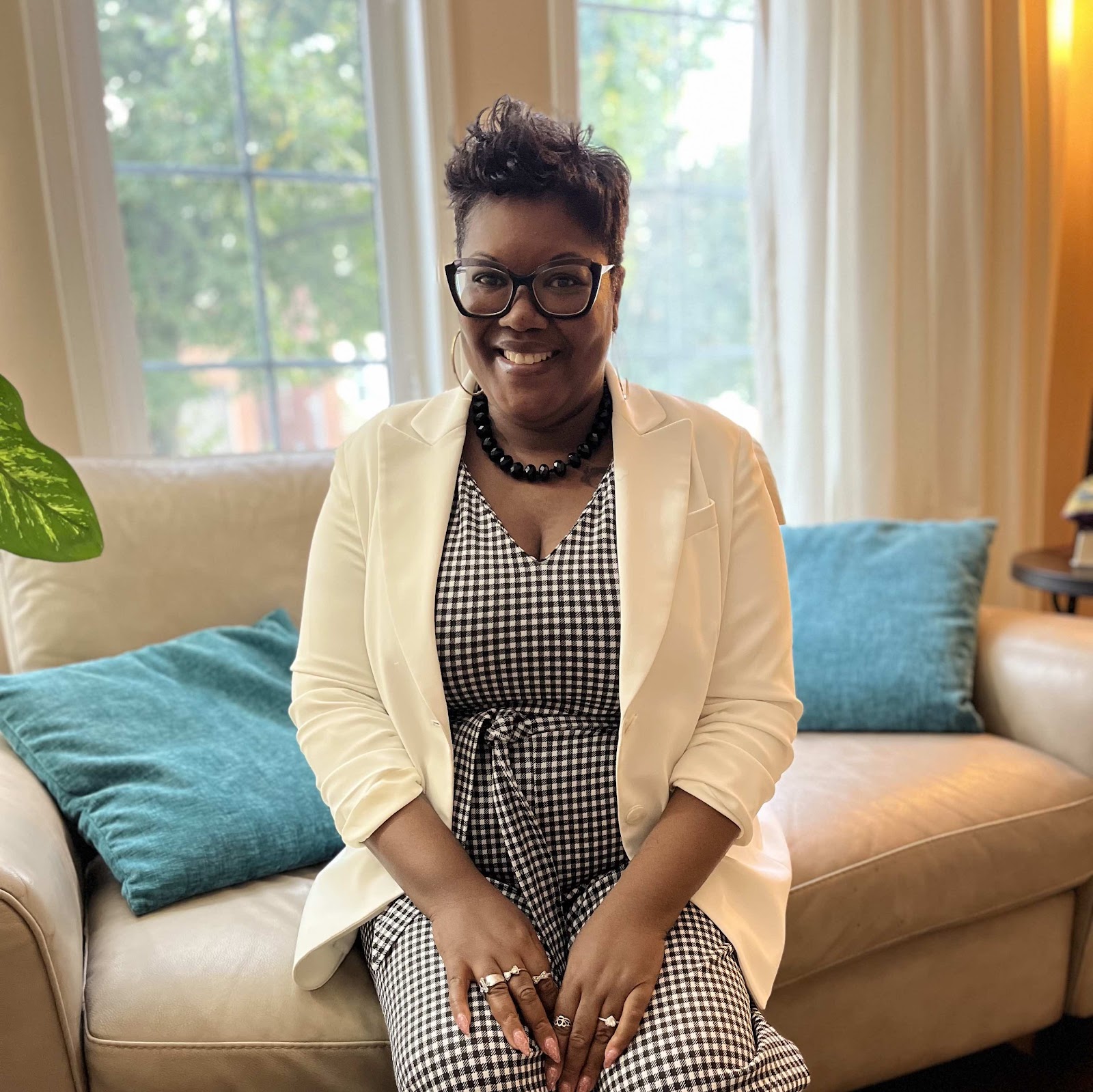 Onika L. Dainty smiling while seated in a bright room